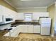 Efficient kitchen with white cabinets, granite countertops, and a full suite of appliances at 4819 Orchid Way # 104, Myrtle Beach, SC 29577