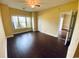 Bright bedroom with large window, dark laminate flooring, and access to another room at 4819 Orchid Way # 104, Myrtle Beach, SC 29577
