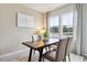 Charming dining area with a wooden table and chairs, offering natural light at 1117 Blueback Herring Way # 05, Conway, SC 29526