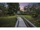 Landscaped backyard with bridge, shed, and lush greenery at 130 Hagar Brown Rd., Murrells Inlet, SC 29576