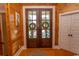 Elegant entryway with double doors, wood walls, and a glimpse of the backyard at 119 Cockle Shell Ct., Pawleys Island, SC 29585