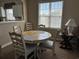 Cozy dining area with round table and four chairs, adjacent to kitchen at 5801 Oyster Catcher Dr. # 1531, North Myrtle Beach, SC 29582