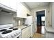 Compact kitchen with white cabinets and granite countertops at 120 North Dogwood Dr. # 113, Garden City Beach, SC 29576