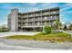 Three-story building with parking and balconies at 120 North Dogwood Dr. # 113, Garden City Beach, SC 29576
