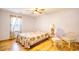 Bedroom with floral bedding, hardwood floors, and a sitting area at 1342 Highway 90, Conway, SC 29526