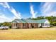 Brick and white home with green metal roof and a spacious yard at 1342 Highway 90, Conway, SC 29526