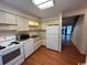 Bright kitchen with white appliances and view to living area at 1210 Pinegrove Dr. # G, Myrtle Beach, SC 29577