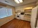 Galley kitchen with white appliances and wood floors at 1210 Pinegrove Dr. # G, Myrtle Beach, SC 29577