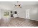 Open floor plan living room, kitchen, and dining area with vinyl plank flooring at 326 Barn Owl Way, Conway, SC 29527