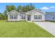 Newly built home with gray siding, landscaping, and a paved driveway at 326 Barn Owl Way, Conway, SC 29527