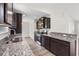 Modern kitchen with dark brown cabinets and granite countertops at 326 Barn Owl Way, Conway, SC 29527