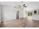 Open living room and kitchen with vinyl plank floors and a view of the backyard at 326 Barn Owl Way, Conway, SC 29527