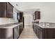 Modern kitchen with dark brown cabinets, granite countertops, and stainless steel appliances at 326 Barn Owl Way, Conway, SC 29527