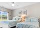 Bright bedroom with two twin beds, featuring coastal decor and ample natural light at 4541 Girvan Dr. # 27-D, Myrtle Beach, SC 29579