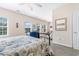 Main bedroom with a metal framed bed, seating area, and large windows at 4541 Girvan Dr. # 27-D, Myrtle Beach, SC 29579