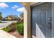 Gray front door of a townhome, with a view of the parking lot at 4541 Girvan Dr. # 27-D, Myrtle Beach, SC 29579