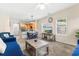 Open living room and kitchen with a blue sofa and dining table at 4541 Girvan Dr. # 27-D, Myrtle Beach, SC 29579