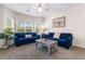 Living room with bay window and comfy blue couches at 4541 Girvan Dr. # 27-D, Myrtle Beach, SC 29579