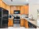 Modern kitchen with wood cabinets and stainless steel appliances at 4541 Girvan Dr. # 27-D, Myrtle Beach, SC 29579