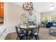 Charming dining area with four chairs and a modern chandelier at 4541 Girvan Dr. # 27-D, Myrtle Beach, SC 29579