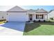 Newly built home with a two-car garage and manicured lawn at 322 Barn Owl Way, Conway, SC 29527
