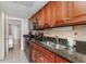 Well-equipped kitchen with granite counters and dark wood cabinets at 1501 S Ocean Blvd. # 1040, Myrtle Beach, SC 29577