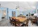 Bright dining area with a large wooden table and access to other rooms at 405 N 30Th Ave. N, North Myrtle Beach, SC 29582