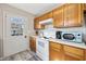 Bright kitchen boasts white appliances, wood cabinets, and exterior access at 405 N 30Th Ave. N, North Myrtle Beach, SC 29582