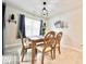 Bright dining room with wooden table and four chairs at 230 Mint Ct., Little River, SC 29566