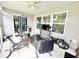 Screened porch with seating, exercise equipment and TV at 230 Mint Ct., Little River, SC 29566