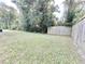 Grass backyard with wooden fence and partial tree coverage at 230 Mint Ct., Little River, SC 29566