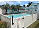 Inviting community pool with surrounding patio furniture at 704 43Rd Ave. S, North Myrtle Beach, SC 29582