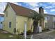 Yellow house exterior with palm tree and landscaped yard at 704 43Rd Ave. S, North Myrtle Beach, SC 29582