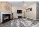 Living area with stone fireplace and wall-mounted TV at 5700 Redgum Dr., Myrtle Beach, SC 29579