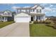 Two story house with attached garage and landscaped front yard at 5700 Redgum Dr., Myrtle Beach, SC 29579