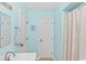 Clean bathroom with light blue walls, shower, and white vanity at 1101 Possum Trot Rd. # C205, North Myrtle Beach, SC 29582