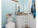 Bathroom with granite countertop, white vanity, and light blue walls at 1101 Possum Trot Rd. # C205, North Myrtle Beach, SC 29582