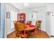 Charming dining area with a round table and four chairs, near a red cabinet at 1101 Possum Trot Rd. # C205, North Myrtle Beach, SC 29582