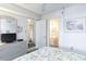 Bedroom with floral bedding and ensuite bathroom at 4001 S Ocean Blvd. # Apt 2C, North Myrtle Beach, SC 29582