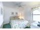 Bedroom with floral bedding and ceiling fan at 4001 S Ocean Blvd. # Apt 2C, North Myrtle Beach, SC 29582