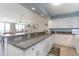 Kitchen features granite countertops and white cabinetry at 4001 S Ocean Blvd. # Apt 2C, North Myrtle Beach, SC 29582