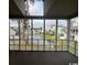 Screened balcony with view of community pond and neighboring units at 3831 Masters Ct. # 137, Myrtle Beach, SC 29577