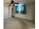 Spacious bedroom with teal curtains, ceiling fan, and carpeted flooring at 3831 Masters Ct. # 137, Myrtle Beach, SC 29577