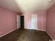 Pink bedroom with two doors and carpet at 3831 Masters Ct. # 137, Myrtle Beach, SC 29577