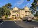 Attractive two-story condo with stairs, palm trees, and parking at 3831 Masters Ct. # 137, Myrtle Beach, SC 29577