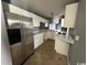 Compact kitchen with white cabinets, stainless steel appliances, and tile floor at 3831 Masters Ct. # 137, Myrtle Beach, SC 29577