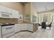 Modern kitchen with white cabinets, granite counters, and breakfast area at 490 Blackberry Ln., Myrtle Beach, SC 29579