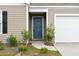 Charming front entrance with a blue door and landscaping at 338 Spruce Pine Way, Conway, SC 29526