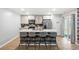 Kitchen island with seating for four and a wood-look accent wall at 338 Spruce Pine Way, Conway, SC 29526