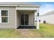 Covered back patio with sliding glass doors and a small yard at 338 Spruce Pine Way, Conway, SC 29526